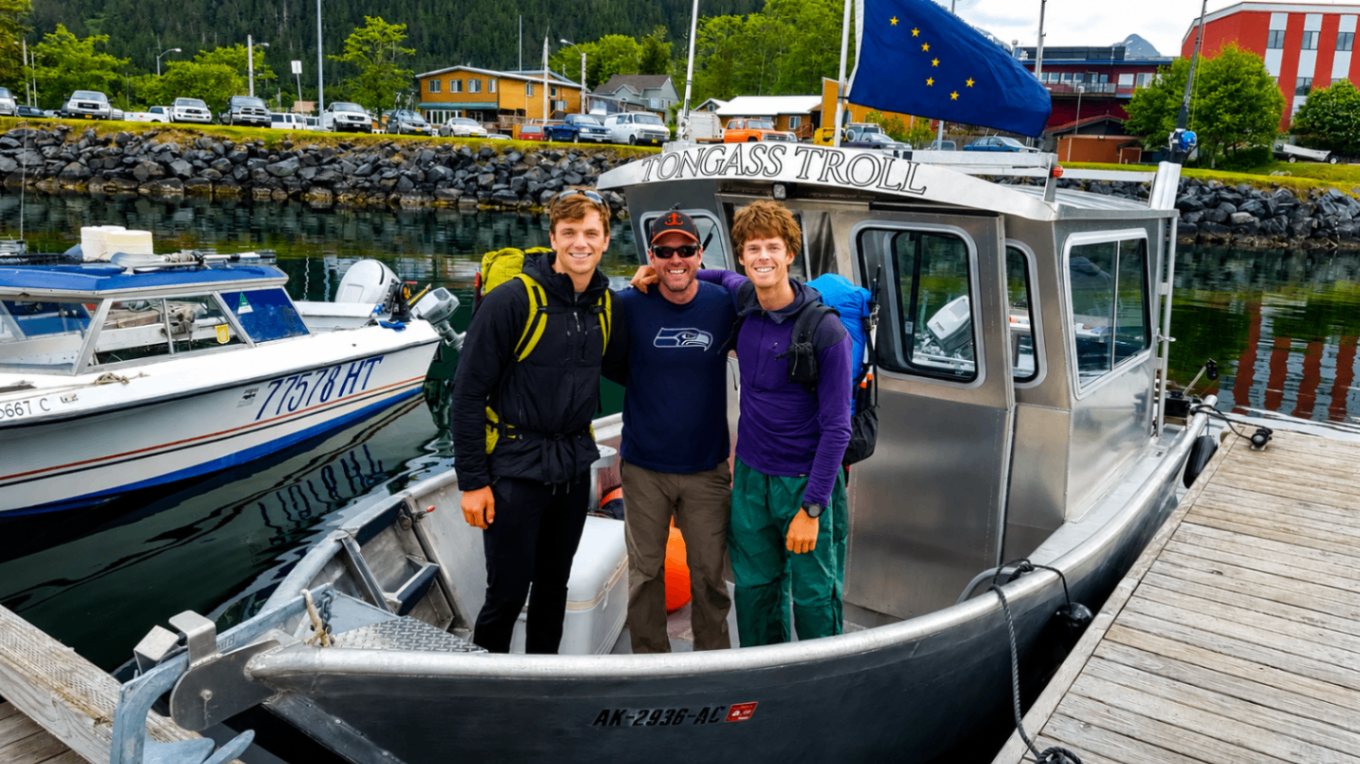 Captain Xander with two hikers in front of the Tongass Troll at Thomsen Harbor
